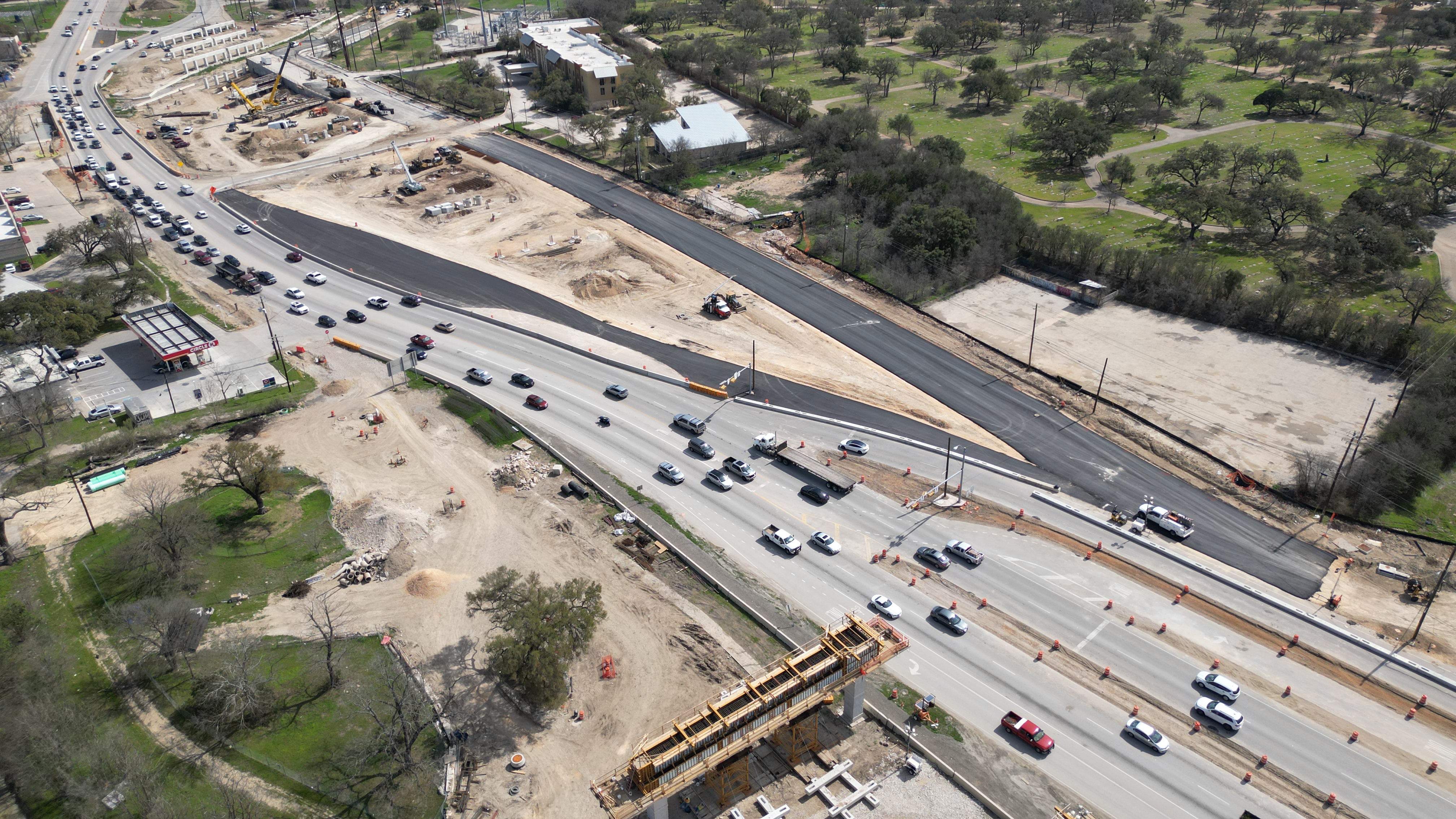 Crews pave the US 290 eastbound frontage road.